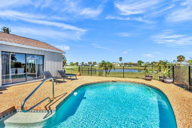 view of swimming pool featuring a water view