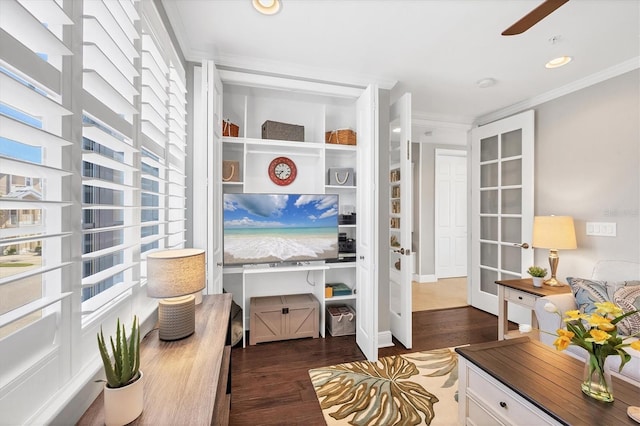 interior space with crown molding, ceiling fan, and dark wood-type flooring