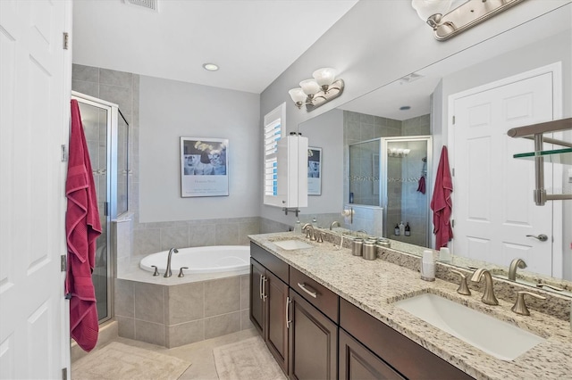 bathroom featuring tile patterned flooring, vanity, and plus walk in shower