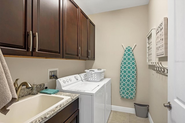 clothes washing area featuring cabinets, separate washer and dryer, sink, and light tile patterned floors