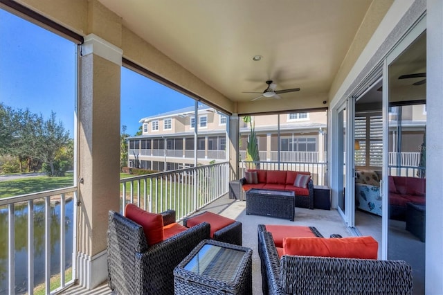 sunroom / solarium featuring a water view and ceiling fan