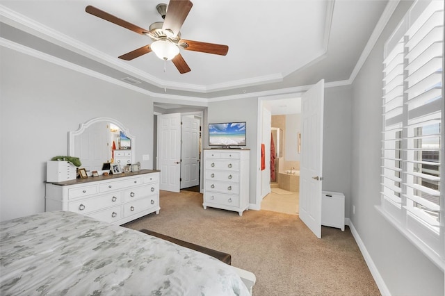 bedroom with ornamental molding, light colored carpet, a raised ceiling, ceiling fan, and connected bathroom