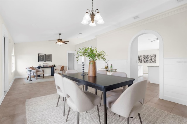 tiled dining room featuring ceiling fan with notable chandelier, lofted ceiling, and ornamental molding