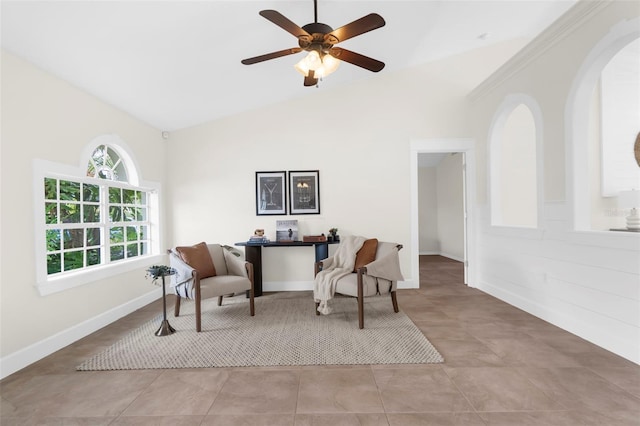 living area with ceiling fan, lofted ceiling, and light tile patterned flooring