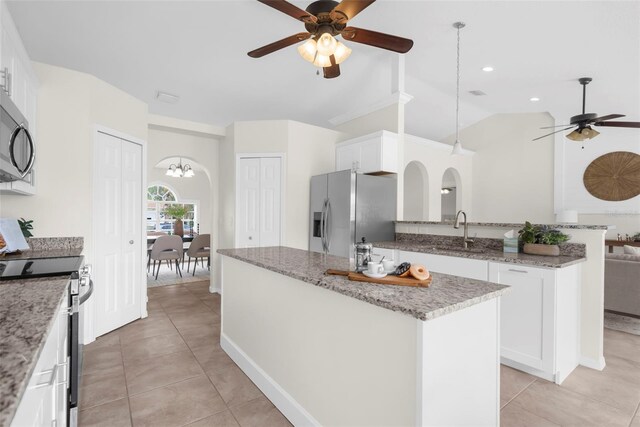 kitchen featuring white cabinets, lofted ceiling, sink, and appliances with stainless steel finishes