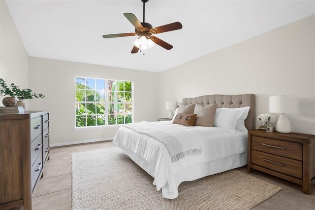 tiled bedroom featuring ceiling fan