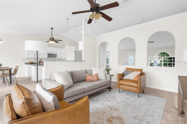 tiled living room with ceiling fan, high vaulted ceiling, and ornamental molding