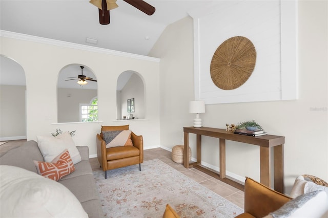 tiled living room featuring crown molding, ceiling fan, and lofted ceiling