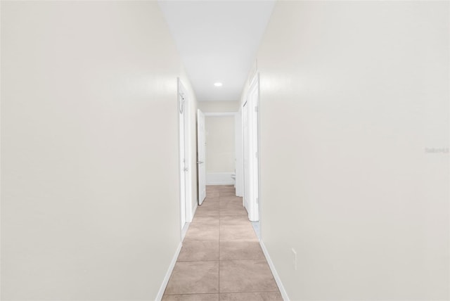 hall with light tile patterned floors