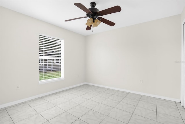 tiled empty room featuring ceiling fan