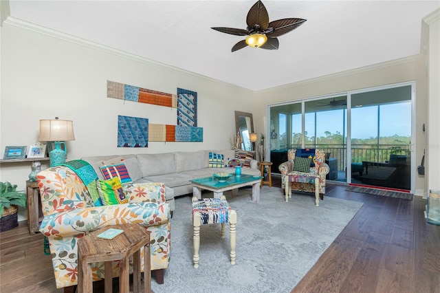 living room with crown molding, ceiling fan, and dark wood-type flooring