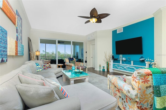 living room with hardwood / wood-style flooring, ceiling fan, and ornamental molding