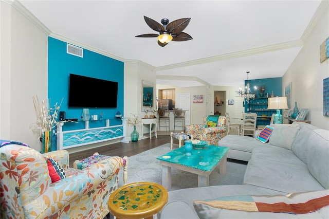 living room featuring crown molding, wood-type flooring, and ceiling fan with notable chandelier