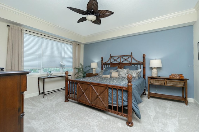 carpeted bedroom with ceiling fan and ornamental molding