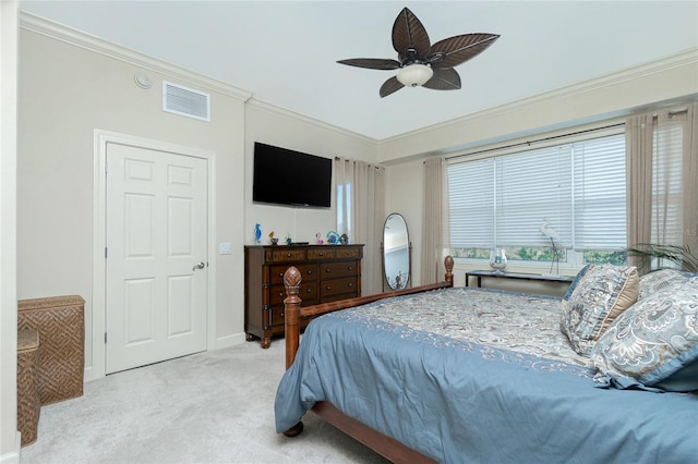 bedroom with ceiling fan, crown molding, and light carpet