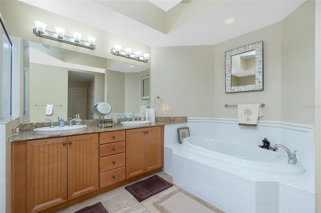 bathroom with vanity, tiled bath, and tile patterned floors