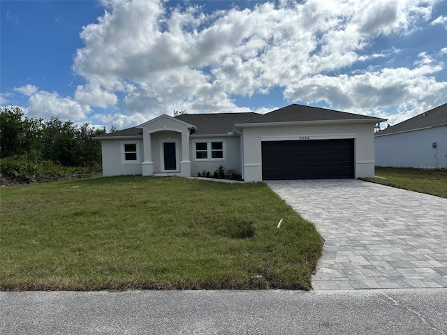 ranch-style home featuring a front lawn and a garage