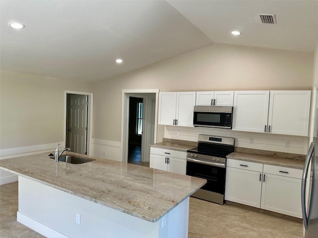 kitchen featuring stainless steel appliances, sink, white cabinets, light stone countertops, and a kitchen island with sink