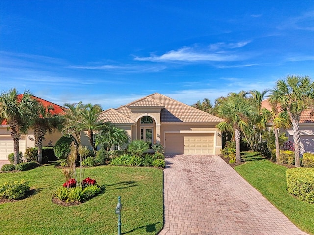 mediterranean / spanish house featuring a front lawn and a garage