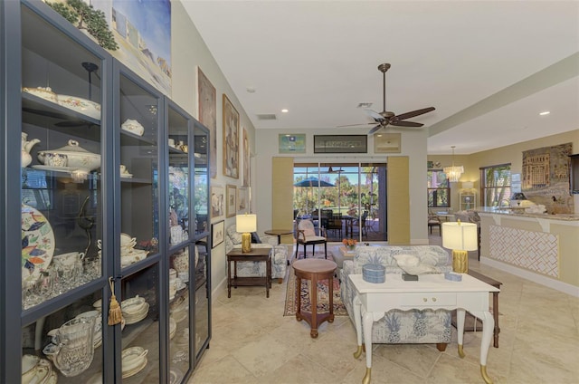 living room with ceiling fan and light tile patterned flooring