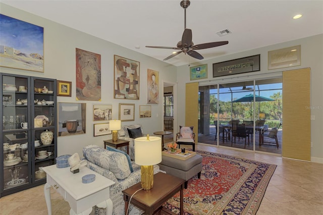 living room with ceiling fan and light tile patterned flooring