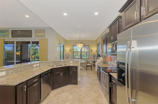 kitchen with plenty of natural light, decorative light fixtures, sink, and appliances with stainless steel finishes