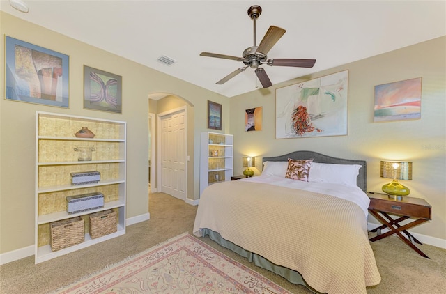 carpeted bedroom with ceiling fan and a closet