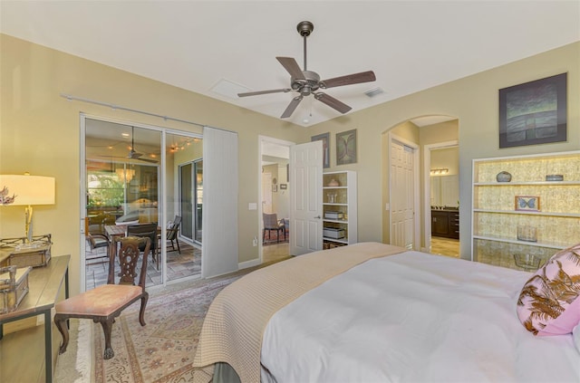 bedroom featuring access to outside, ceiling fan, and ensuite bathroom