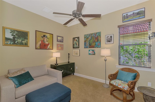 living area with ceiling fan and light colored carpet