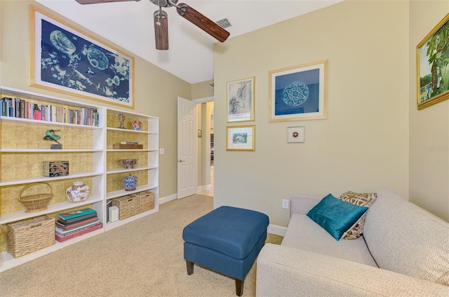 sitting room featuring ceiling fan and light carpet