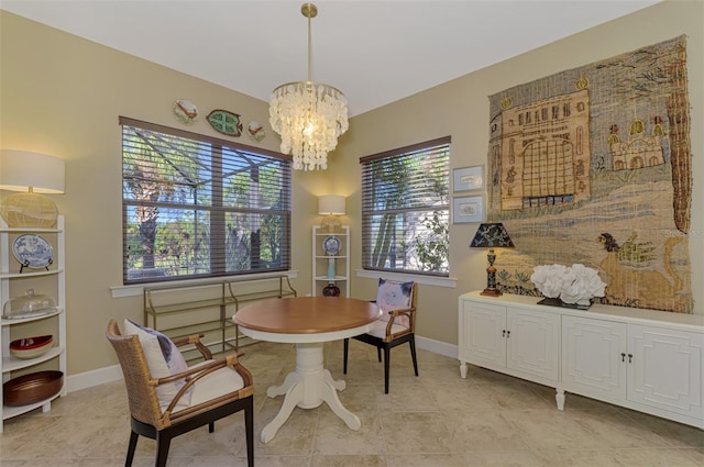 dining space with light tile patterned flooring and an inviting chandelier