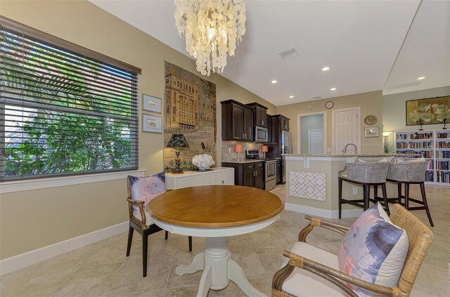 dining room featuring a notable chandelier and light tile patterned floors