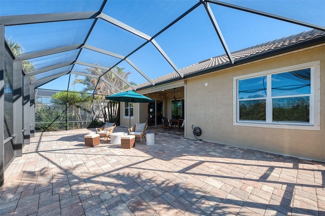 view of patio featuring glass enclosure and ceiling fan