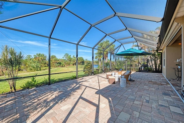 view of patio with glass enclosure