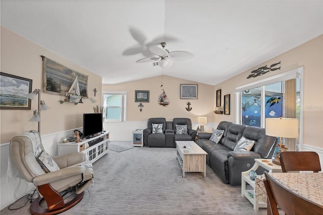 carpeted living room featuring ceiling fan and vaulted ceiling