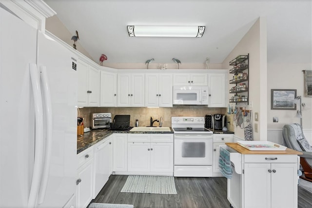 kitchen with white appliances, backsplash, white cabinets, sink, and dark hardwood / wood-style floors