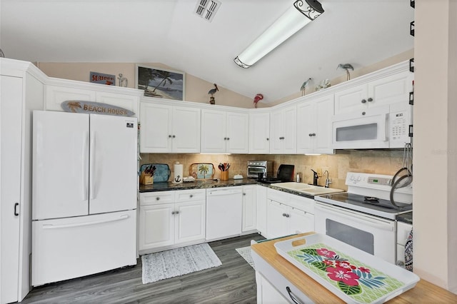 kitchen featuring dark hardwood / wood-style flooring, white appliances, vaulted ceiling, sink, and white cabinetry