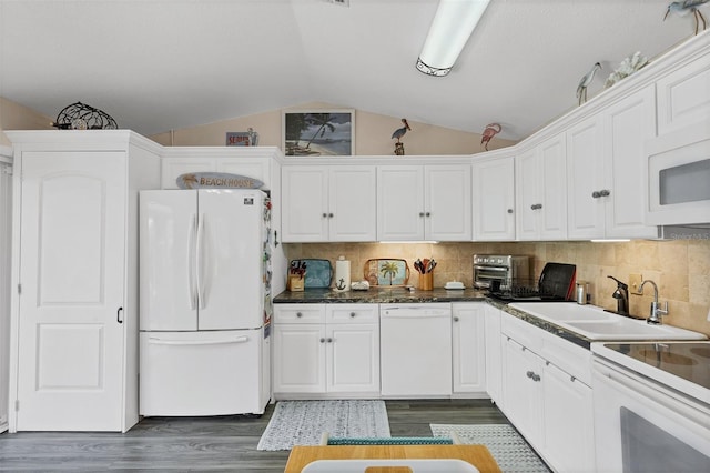 kitchen with dark hardwood / wood-style flooring, white appliances, vaulted ceiling, sink, and white cabinetry