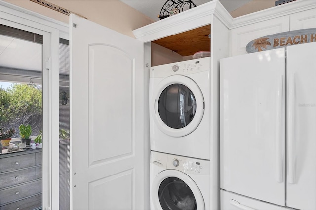 laundry area featuring stacked washer / drying machine