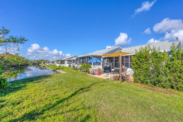 view of yard with a patio area and a water view