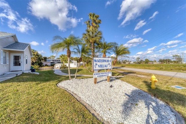 community / neighborhood sign with a yard