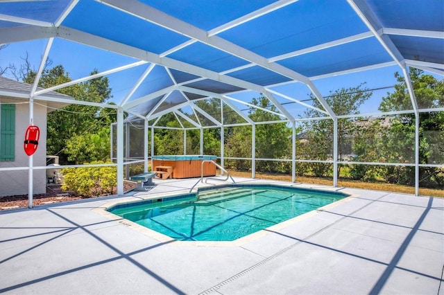 view of pool with a hot tub, a patio, and glass enclosure