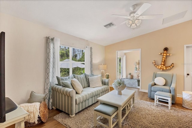 living room with hardwood / wood-style flooring, ceiling fan, and lofted ceiling