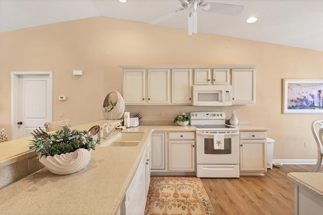 kitchen featuring sink, vaulted ceiling, light hardwood / wood-style flooring, ceiling fan, and white appliances