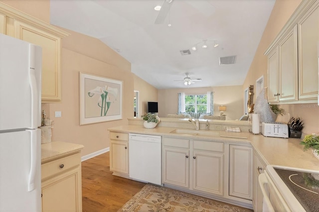 kitchen with sink, white appliances, light hardwood / wood-style floors, ceiling fan, and cream cabinets