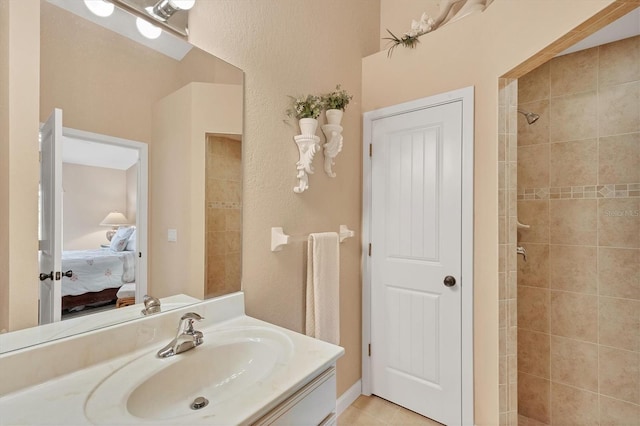 bathroom with vanity and a tile shower