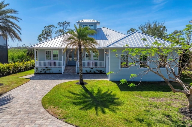 view of front facade with covered porch and a front yard