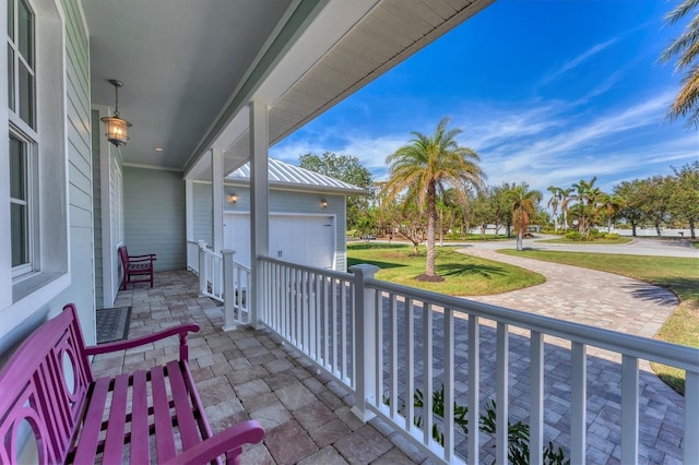 view of patio / terrace with covered porch and a garage