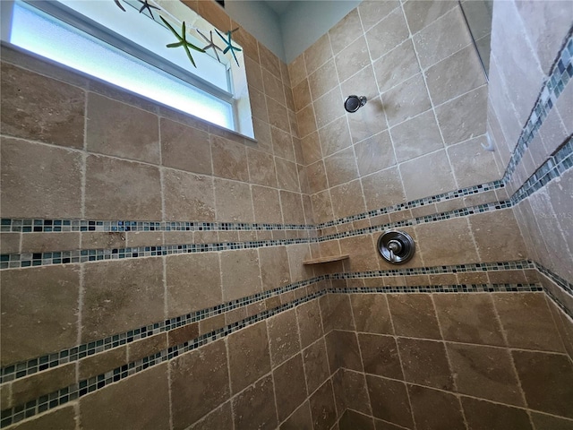 bathroom with a tile shower