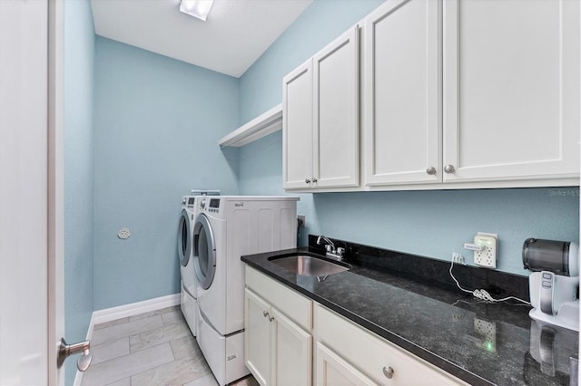 laundry room featuring sink, cabinets, and washing machine and dryer